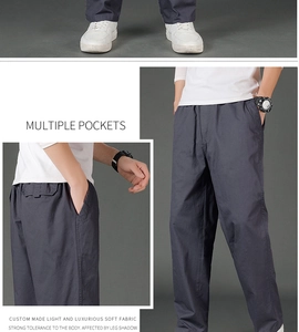 Detail view of charcoal grey casual cargo pants featuring elastic waist and side pockets