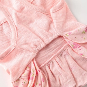 Close-up of pink pet floral dress featuring cotton slub texture and floral ruffle details