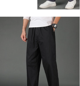 Close-up of black men's casual trousers featuring elastic waist and functional side pockets