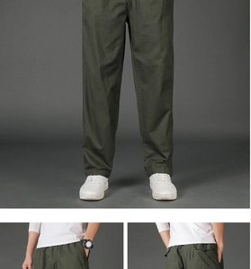 Detail of army green straight leg cargo pants with functional pockets and cotton fabric