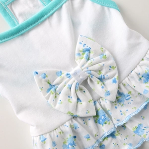 Close-up of floral pet dress with a large blue bow and delicate ruffled hem details