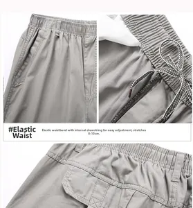 Detail of elastic waist with drawstring on grey cargo pants showing 8-10cm stretch range