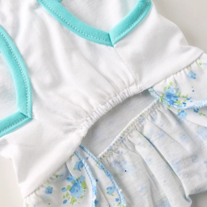 Close-up of pet floral dress showing elastic waist detail and blue knit fabric texture