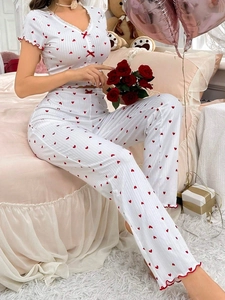 Close-up of women's ribbed pajamas with red heart print and delicate ruffle trim details