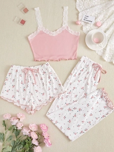 Detailed flat lay of pink ribbed camisole and floral pajama set with lace trim