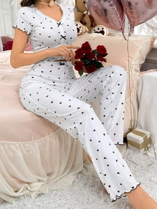 Detail of V-neck heart print loungewear with ribbed texture and ruffle hem edges