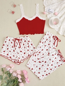 Detailed flat lay of red lace camisole and floral print pajama set with lounge shorts
