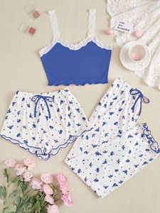 Detailed flat lay of a floral three-piece pajama set with lace camisole and soft pants