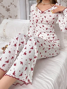 Close-up of floral pajama set featuring red lettuce edge trim and ribbed texture fabric