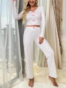 Detail of V-neck pajamas featuring pink heart prints, ruffled hems and bowknot accents