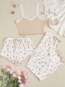 Detailed flat lay of a floral three-piece loungewear set with lace trim and bow accent