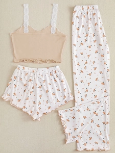 Flat lay of floral 3-piece loungewear set with lace trim camisole and matching pants