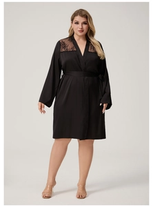 Detailed view of the black satin robe featuring intricate lace patchwork on shoulders