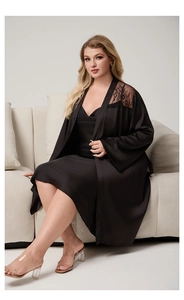 Detail of plus size black satin robe with intricate lace patchwork on shoulder
