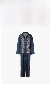 Close-up of elegant floral print patterns on dark blue satin long-sleeve pajama set