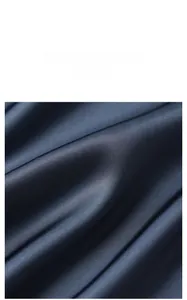 Macro detail of navy blue satin fabric showing smooth texture and elegant drapes