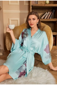Close-up of light blue satin bathrobe featuring traditional floral print and smooth texture