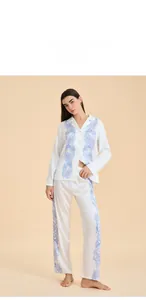Detailed view of women's satin pajama set featuring blue damask prints and silk-like finish