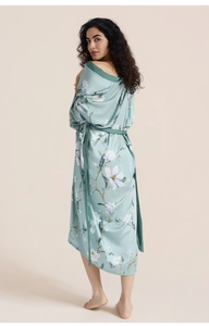 Detail view of floral print satin robe back with elegant magnolia pattern and belt