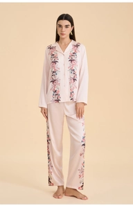 Detail of floral printed satin pajama set featuring silk-like texture and soft pink color