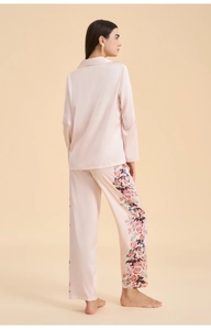 Detailed view of champagne satin pajama set featuring elegant floral print on trousers