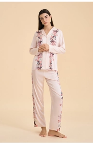 Detailed front view of women's pink satin pajama set featuring elegant floral prints