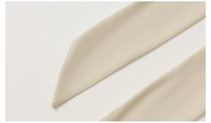 Detailed macro view of the cream satin robe waist tie with precise stitching and fabric texture
