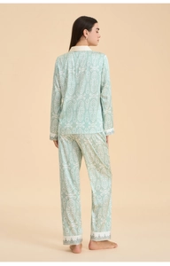 Detail of mint green pajama set showing back view and ethnic ikat pattern texture