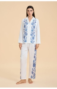 Detail view of white satin pajamas with blue floral paisley print and button-up collar