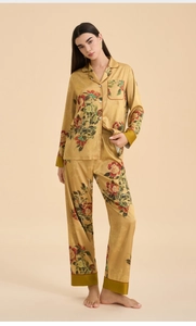 Detail view of gold floral satin pajamas with elegant peony print and notched lapels