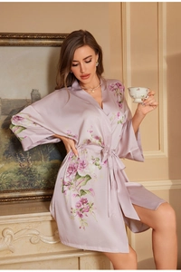 Detail view of a luxury satin floral bathrobe featuring an elegant tie-waist and V-neck design