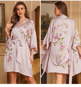 Detail view of a lavender satin floral bathrobe with 3/4 sleeves and matching waist belt
