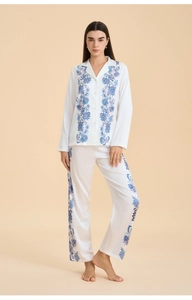 Full-body shot of women's satin floral pajama set with long sleeves and lounge trousers