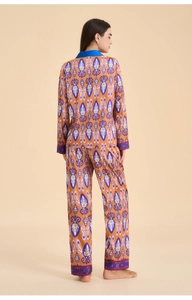 Detailed view of the ethnic ikat print pattern on a satin long-sleeve pajama set
