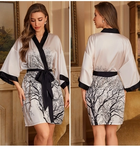 Detail view showing front and back of cream satin robe with black branch patterns