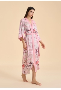 Détail d'un peignoir en satin rose pâle avec imprimé floral de style chinois et ceinture