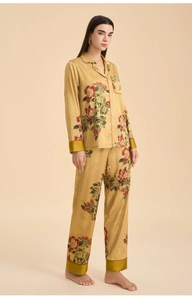 Detail of elegant champagne floral silk pajamas featuring satin cuffs and buttoned lapels