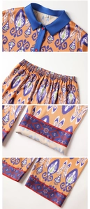 Detail view of ethnic satin pajamas showing collar buttons, waist elastic, and hem patterns