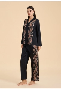 Detailed view of women's black satin pajama set with elegant paisley floral prints