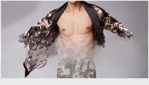 Detail of men's black silk robe featuring golden dragon patterns and satin shawl collar