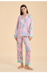 Detail of pink floral satin pajama set featuring light blue piping and elegant lapels