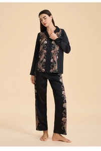 Detail of black satin pajama set with vintage paisley print on sleeves and pants