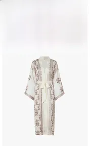Detailed view of satin robe featuring vintage palm leaf prints and a matching waist belt