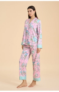Detail of floral pink pajama set featuring contrast blue satin trim on sleeves and cuffs