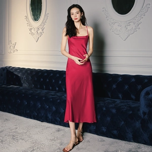 Detailed close-up of dark pink satin slip dress with thin straps and elegant cowl neck design