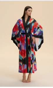 Detailed view of women's long satin robe with artistic ink print and wide kimono sleeves