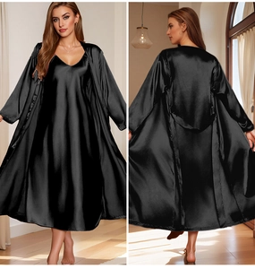 Detail of elegant black satin nightgown and matching long robe set with silk luster