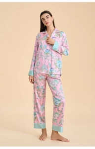 Floral pajama set detail showing pink fabric with mint green satin cuffs and collar