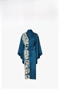 Detail of teal satin robe featuring tropical leaf print and asymmetric stitching