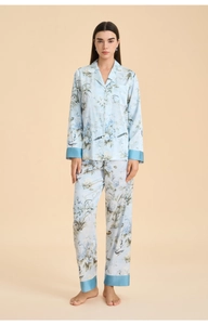 Detail of light blue floral pajama set featuring a contrast navy trim on cuffs and hem